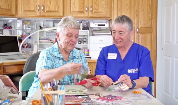 Danville Support Services staff with elderly lady working on crafts